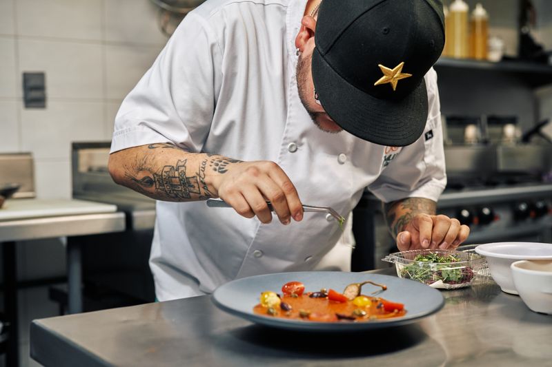 Wing Snob chef carefully preparing fresh wings in the kitchen